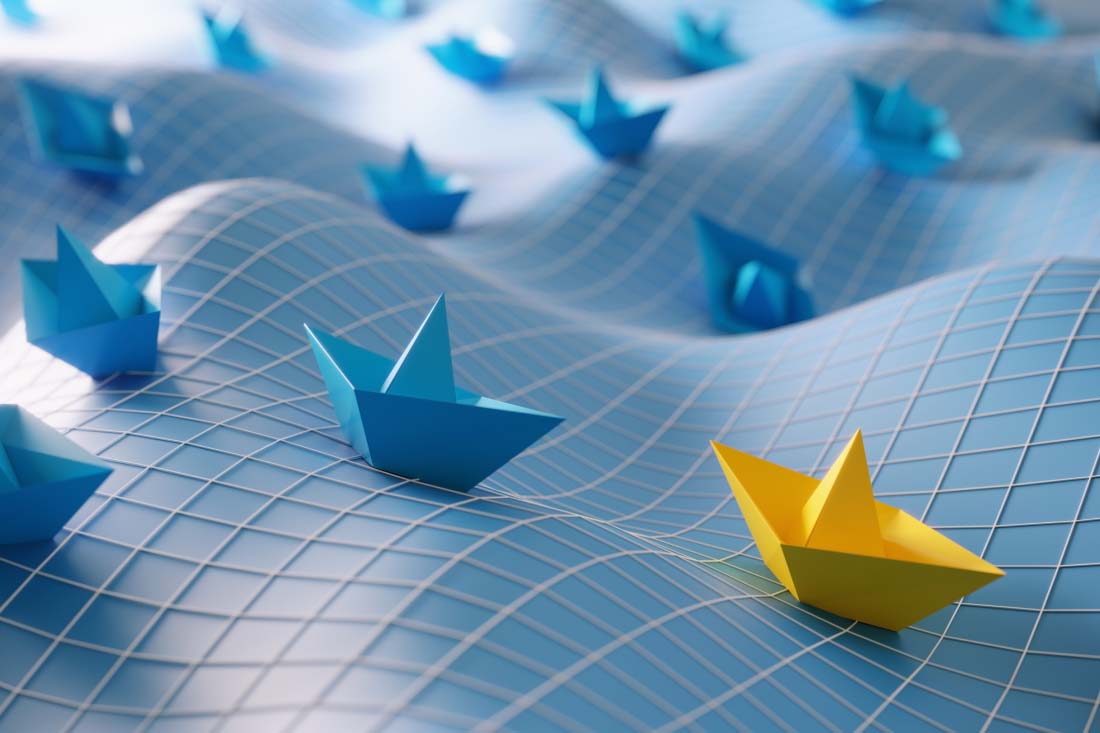 a yellow ship in a sea with blue ships dispersed and following the yellow ship to signal hybrid workforce leadership.
