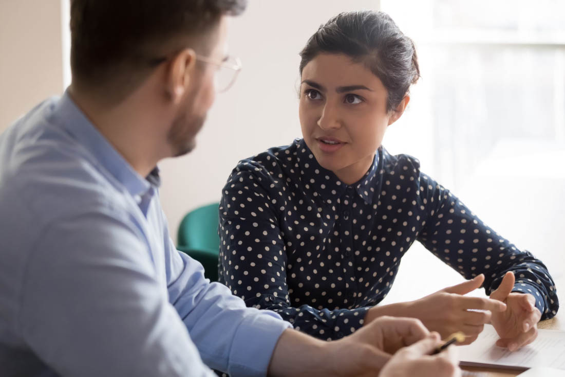 Two employees exchanging remote work tips.