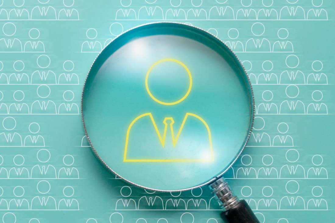 A micro-scope looking at one employee among many to signify staff tracking.