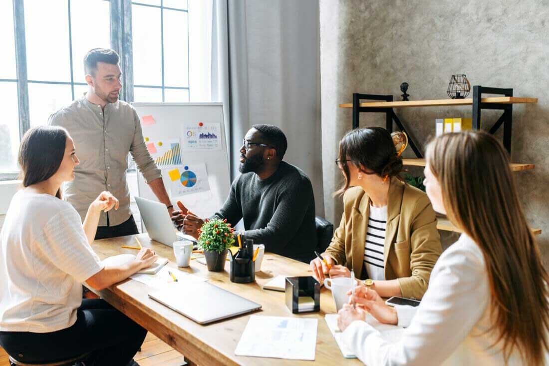 An in-office team discussing office strategy during a crisis.
