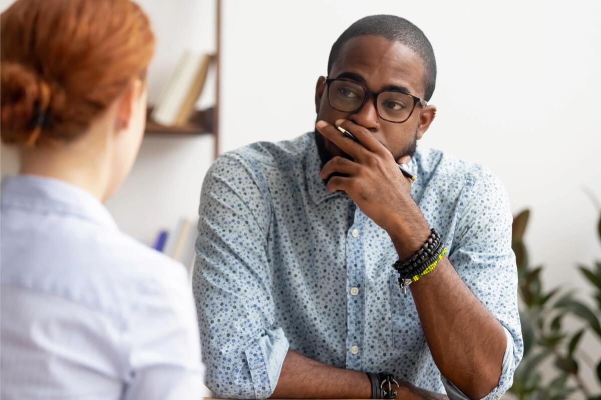 man wearing glasses listening thoughtfully during a conversation