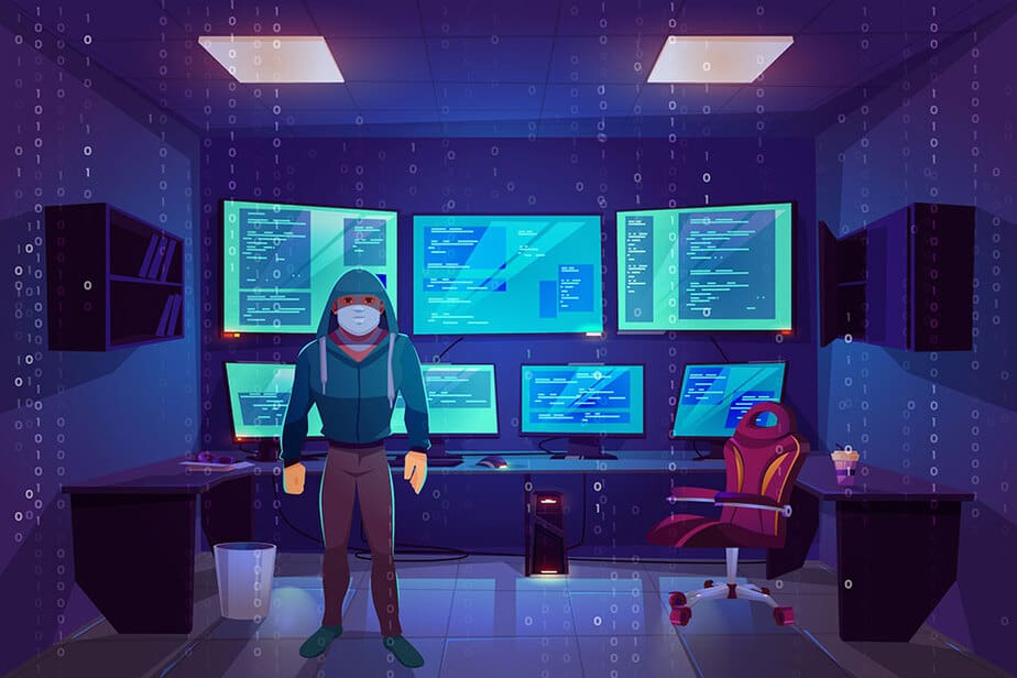 A man in a hooded jacket facing away from a u shaped desk taking up the whole wall and 7 monitors filling up the wall.